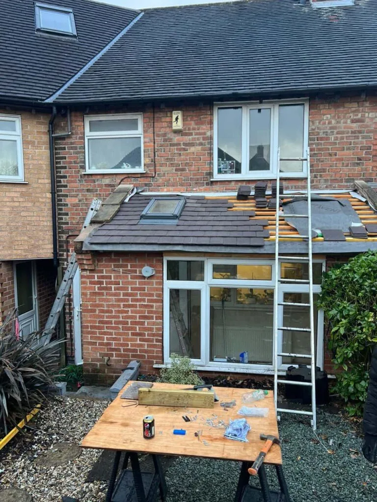 This is a photo of a roof extension that is having new roof tiles installed. This is a photo taken from the roof ridge looking down a tiled pitched roof on to a flat roof. Works carried out by Portsmouth Roofing Repairs