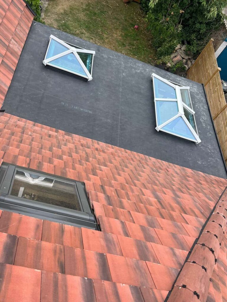 This is a photo taken from the roof ridge looking down a tiled pitched roof on to a flat roof. Works carried out by Portsmouth Roofing Repairs