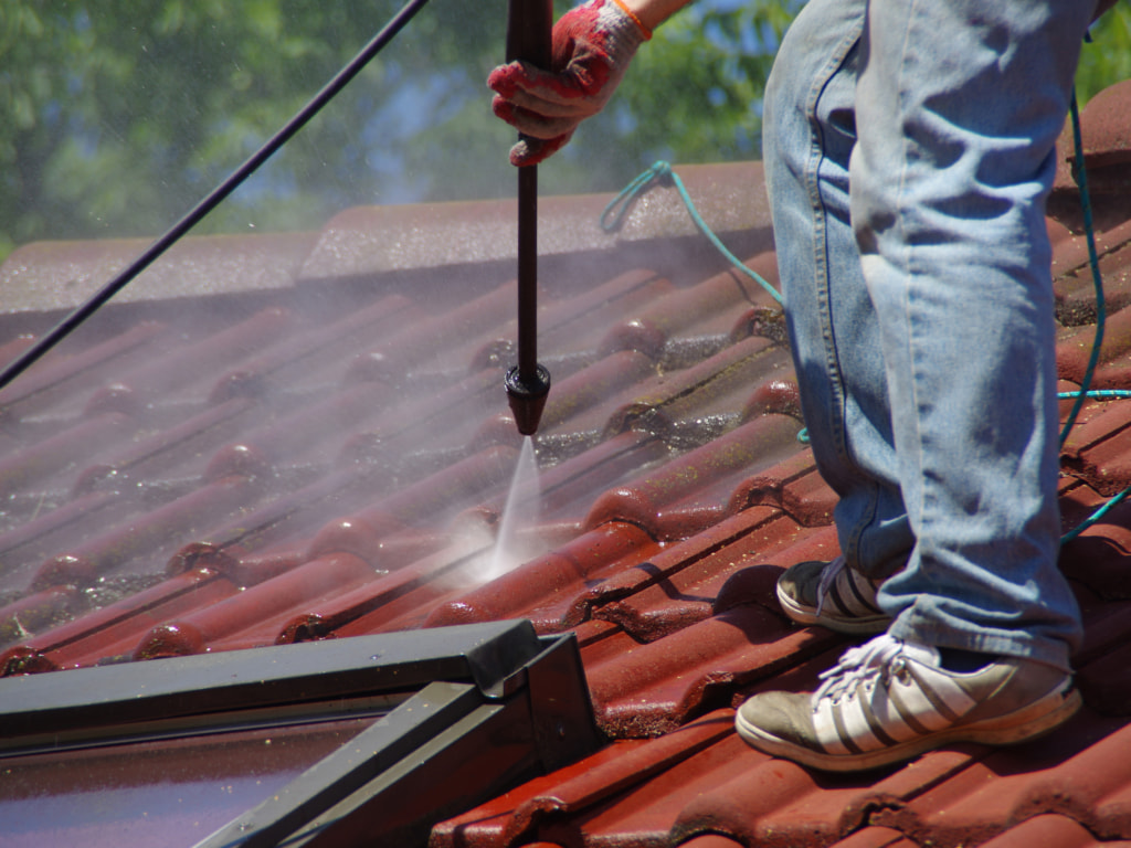 Roof cleaning using a power washer
